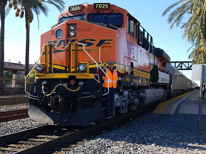 Tumbas with locomotive 7025, which was used in the Southern California Christmas Train in 2019 that he volunteered to operate.